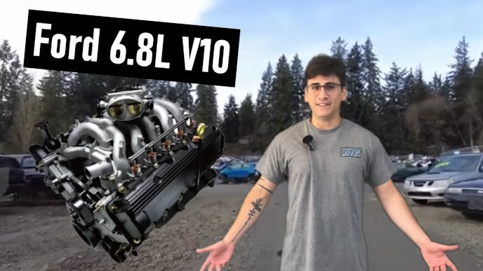 Man standing up with Ford 6.8L V10 hovering beside him