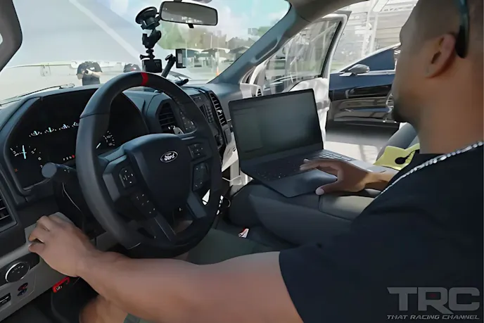 man in a car with a laptop