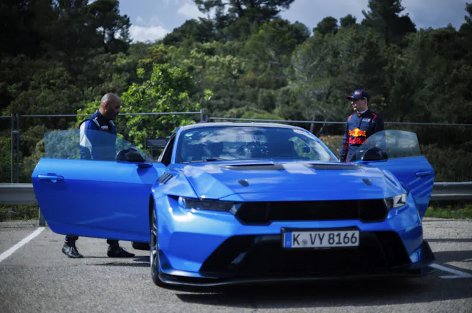 Blue Mustang with door open ready to accept passengers