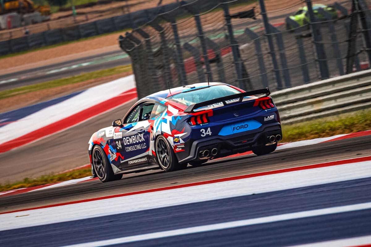 Multi colored Mustang Racing on track