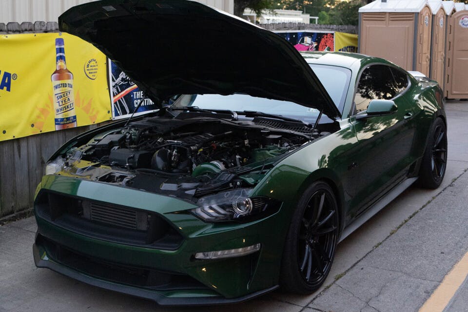 Green S650 Mustang with hood open