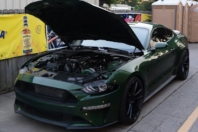 Green S650 Mustang with hood open