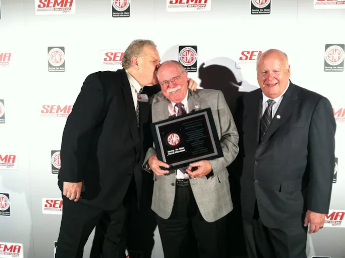 Menzler was honored as the SEMA Person of the year in 2011. That's Airaid's Chris Thompson on the left and Comp's Scooter Brothers on the right.
