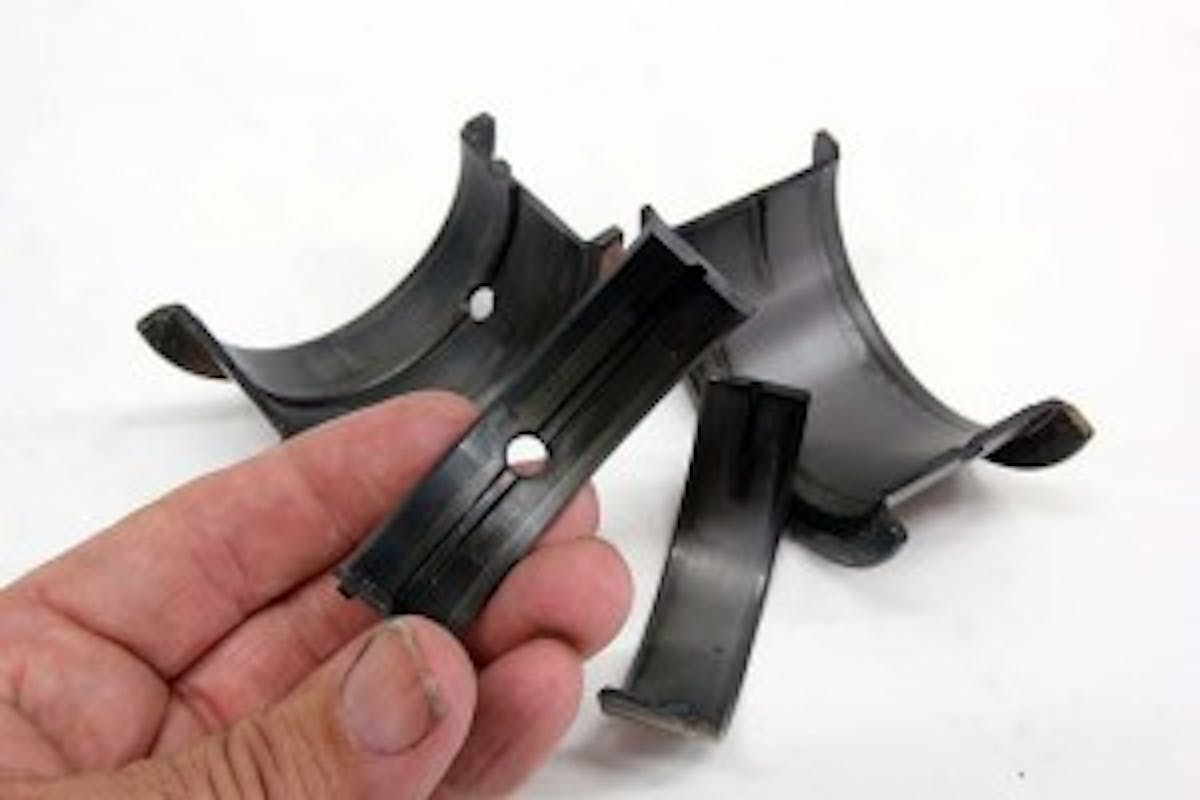 These are Speed-Pro performance tri-metal high performance rod and main bearings. Some people mistakenly think there is something wrong with these bearings because of their odd coloration. Federal-Mogul does not flash coat its tri-metal performance bearings, which is why the bearing looks like this. This is completely normal appearance for a tri-metal bearing.