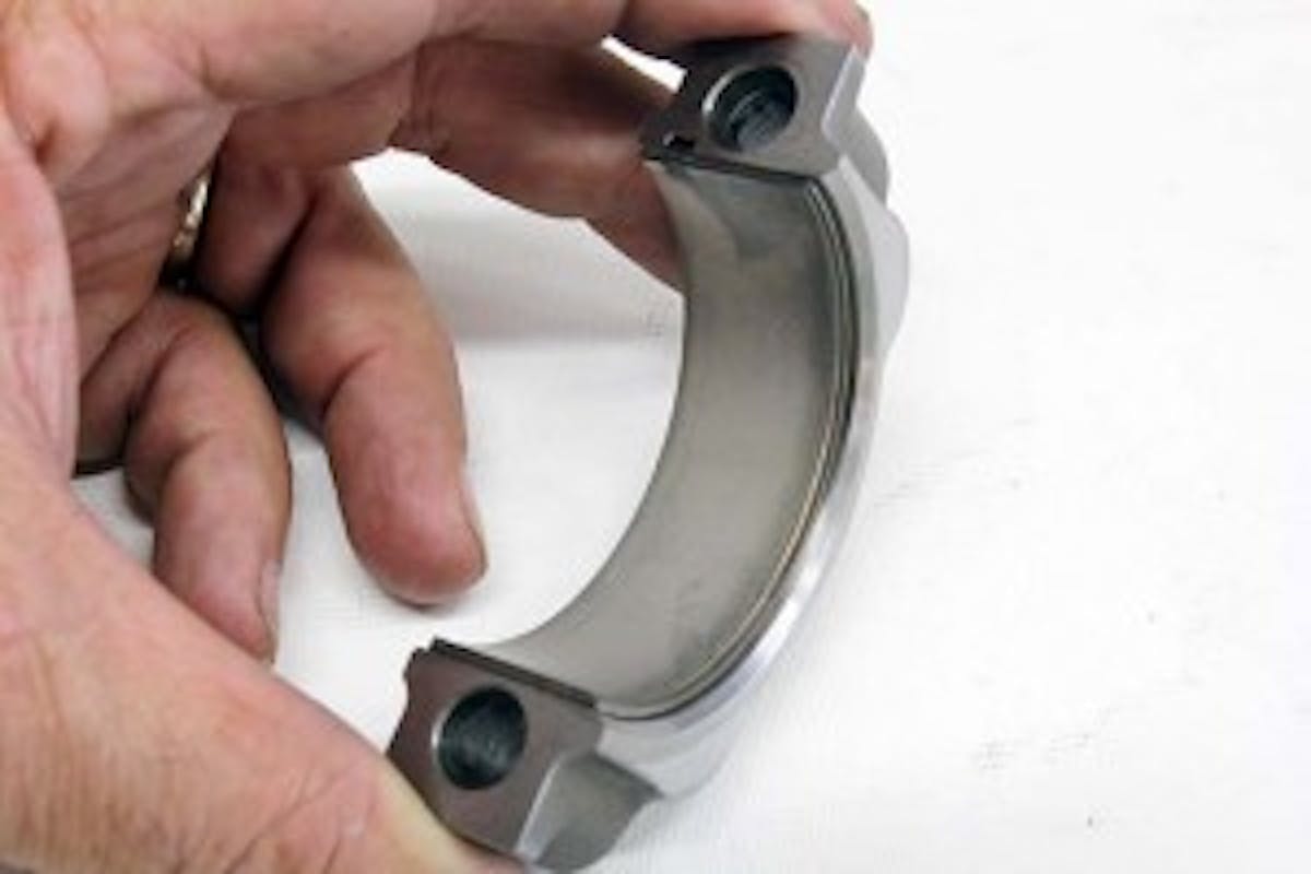 If you look closely at a high performance set of rod bearings, the inserts may be marked “upper” and “lower.” This is because the bearing insert has been narrowed on one side to clear the radius against the cheek of the crank. Be careful to always place them in their proper position to prevent the bearing from rubbing on the crank fillet radius. When inserted properly, the narrow side of the bearing will be on the same side as the chamfer on the rod and cap.