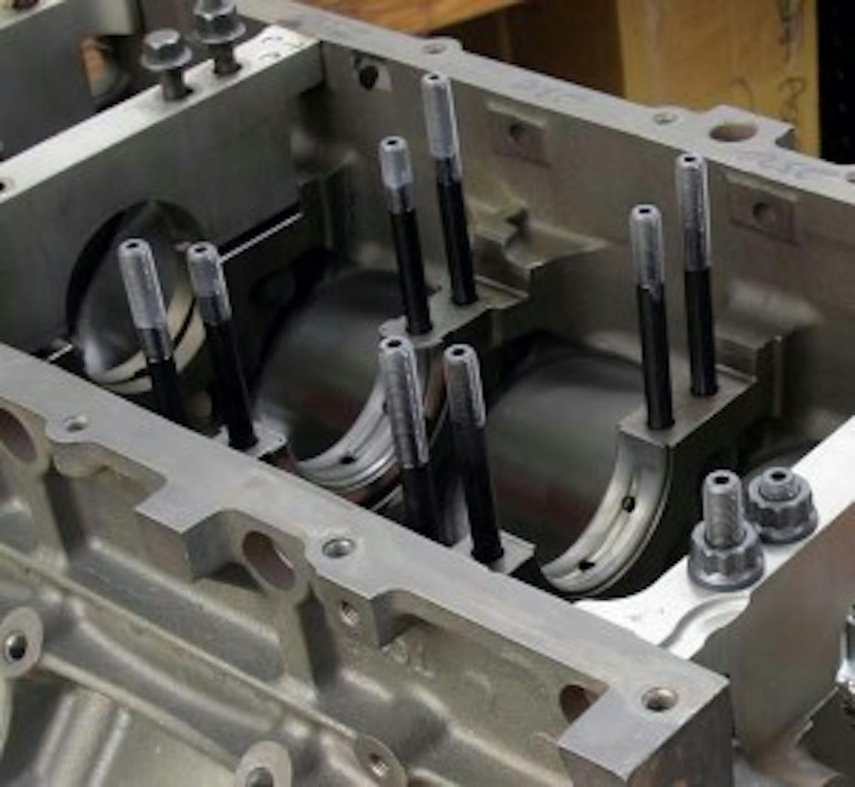 Anytime a set of rod bolts are pressed into place, the rods should be resized to accurately maintain not only the proper inside diameter but also concentricity. Changing from bolts to studs in main bearings will also change the clearance due to different load characteristics. Changing to main studs often does not require line honing, but you should measure the clearance as it could change.