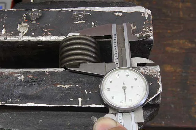 If you have a spring of unknown origin, you can measure coil bind by carefully placing the spring in soft aluminum jaws in your vise, collapsing the spring and measuring the height. Sometimes you may discover your spring binds at a slightly lower number than listed in the catalog. That’s why it pays to measure. Never place a spring in a vise where the jaws can contact the outside of the coils – this can damage the spring.