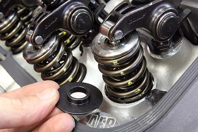 Spring seats can be either id or od style and come in a variety of sizes. The od style (under the spring on the engine) is shaped like a cup and may require head machining to fit in the spring pocket. More common are the id style (left) that locate the spring using an inside step that is sized to snuggle up to the spring’s inside diameter. These seats can also be used as spacers to reduce installed height if necessary.