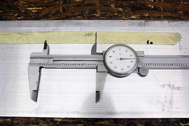 Next, we laid the tape on a piece of aluminum and measured the distance from our TDC mark on the tape to the two stop positions. They were within 0.005 –inch of the same so we’ll call this accurate.