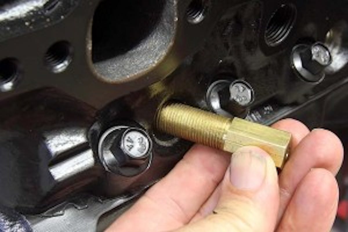 With the heads on the engine, the same procedure works with a spark plug style piston stop like this one. Be careful to always rotate the engine over by hand when using piston stops. Never use a starter motor unless you think replacing broken pistons is fun.