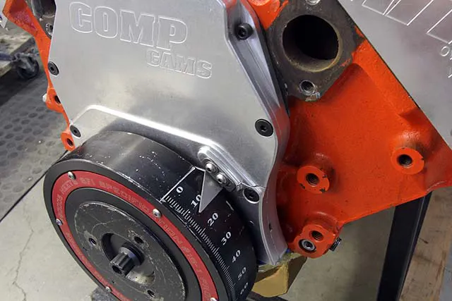 Engines with marked balancers are easy to check as you don’t need a timing tape. A standard timing light will work. Note here on this big-block that we are using the straight edge of the reference plate to indicate zero.