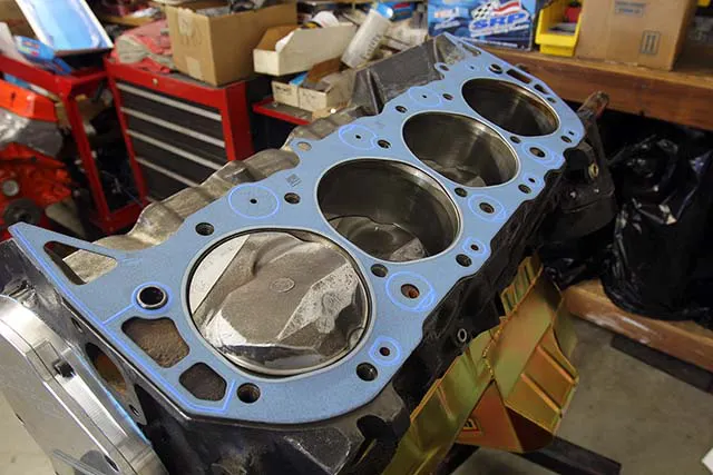 Make sure you use a compressed head gasket, or if the gasket is new you will need to fully torque the head in place. With a used gasket, full torque is not necessary. Retain the head with at least five head bolts torqued to 50 ft-lbs to load the head properly.