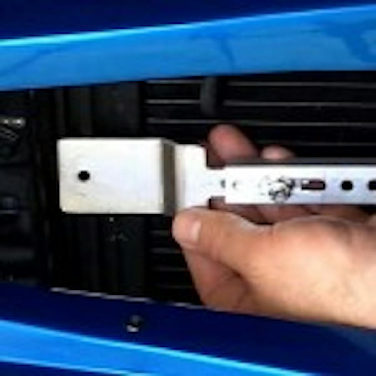 Once you've found the ideal position, you can begin assembling the mounting kit. Flex-a-lite's mounting kit comes in three pieces – two attachment tabs and a center slider so that you can mount the cooler to practically any width Flex-a-fit Radiator.