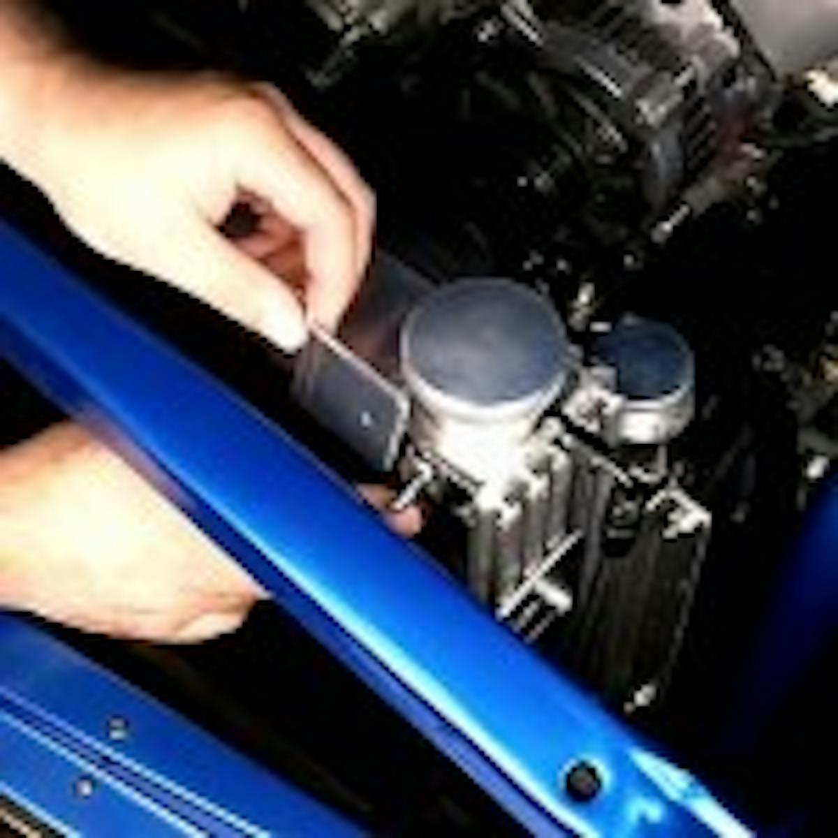 If you have to, you can loosen the radiator from its mounts and tilt it back to give yourself more room to work. Insert the mounting kit's T-bolts into the radiator channels in the tank and install the sides of the brackets. The T-bolts allow you to set the height exactly where you want it.