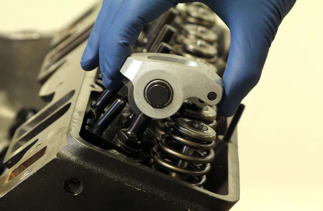 This is a beehive spring below the Lunati aluminum rocker. Notice how the top coils are significantly smaller than the rest of the spring. This helps cut weight of both the spring and retainer.