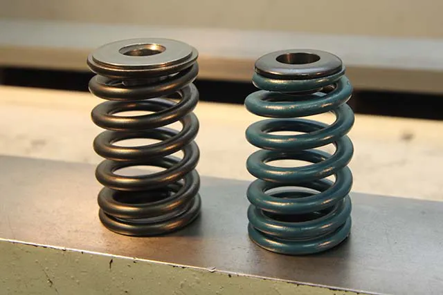Here's a comparison shot between a conventional straight valve spring and its mating retainer (left) and a beehive spring (right). The difference in weight of the retainers is only a couple of grams, but at 7,000 rpm or more that really adds up.