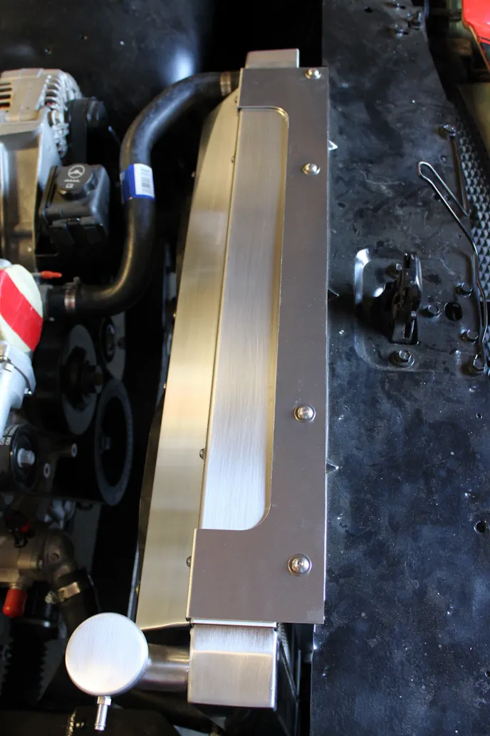 Mattson installed nutserts in the top of the core support and a custom panel that looks great and holds the radiator firmly in place. A pair of brackets holds the bottom of the radiator in place using rubber isolators to avoid vibration damage.