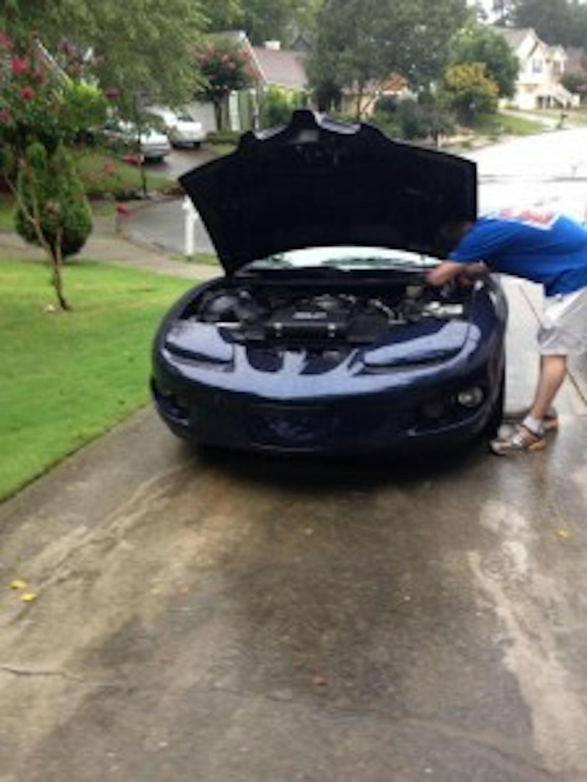 I couldn't think of the best place to but this, but I wanted to thank our friend Joe who has easily offered up more parts and time turning wrenches on Vendetta than anyone outside of this house. Pictured changing my hydraulic fluid, in the rain.