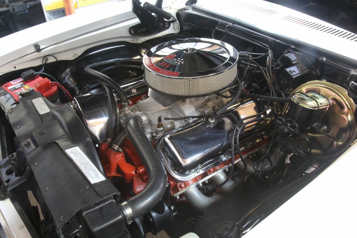This is Doug Eisberg’s engine compartment just before the power brake booster pump swap. We’ll show you how an enterprising pair of San Diego car guys fabricated a cool power brake booster system that really works.