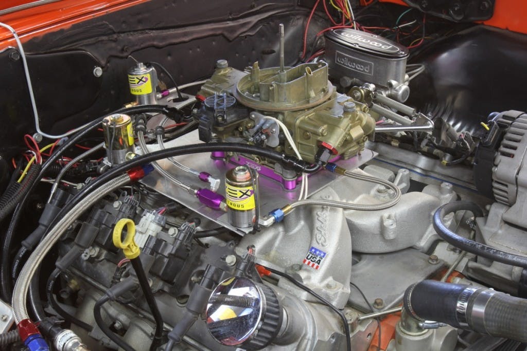Converting an LS engine to a carburetor is actually pretty easy. Unbolt the factory intake, bolt on an intake like this Edelbrock Performer RPM and a Holley 3310 vacuum secondary carburetor and you’re halfway there. This will also require ignition control.