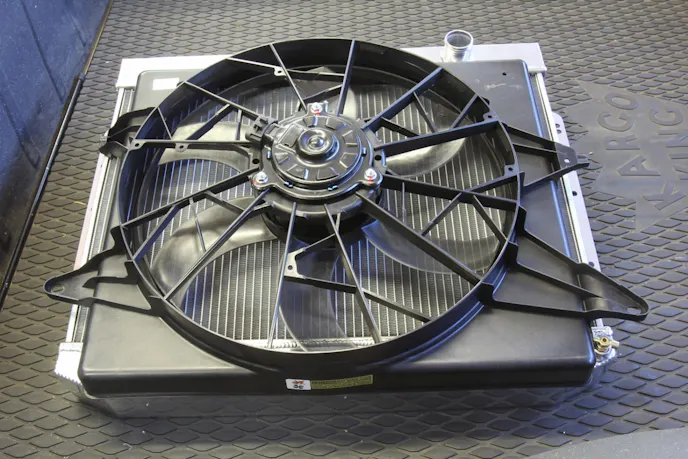 Mounting the MK8 fan to this Holley Frostbite radiator will require cutting some access holes in the built-in shroud. Always mount an electric fan to permanent external mounts. Never mount an electric fan to the radiator core using those cheap zip ties. Fan vibration will eventually cut through the tubes on a horizontal radiator or damage the fins on a vertical radiator.