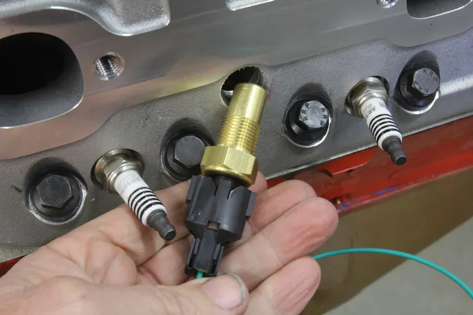 Mounting the MK8 fan to this Holley Frostbite radiator will require cutting some access holes in the built-in shroud. Always mount an electric fan to permanent external mounts. Never mount an electric fan to the radiator core using those cheap zip ties. Fan vibration will eventually cut through the tubes on a horizontal radiator or damage the fins on a vertical radiator.