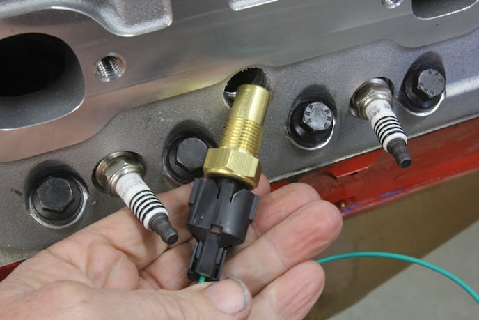 Mounting the MK8 fan to this Holley Frostbite radiator will require cutting some access holes in the built-in shroud. Always mount an electric fan to permanent external mounts. Never mount an electric fan to the radiator core using those cheap zip ties. Fan vibration will eventually cut through the tubes on a horizontal radiator or damage the fins on a vertical radiator.