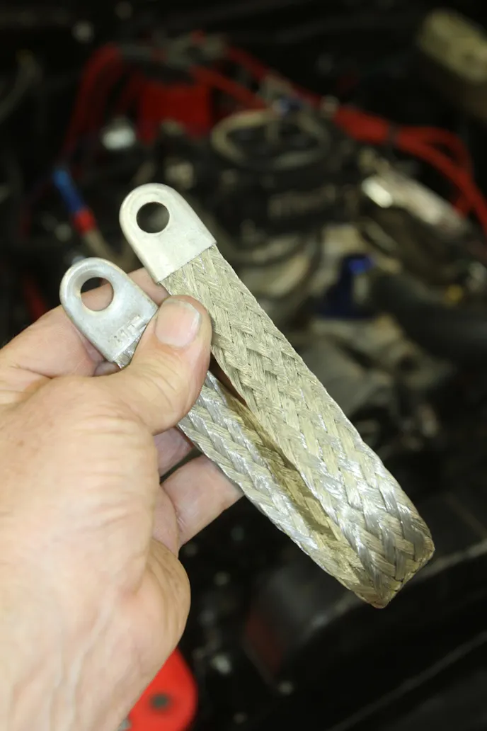 Good grounds are especially important when fighting noise issues with digital components. These wide, woven ground straps may not be pretty, but they serve a purpose of assisting in negating stray voltages. Also make sure there is a clean ground between the chassis, body, and the engine. 