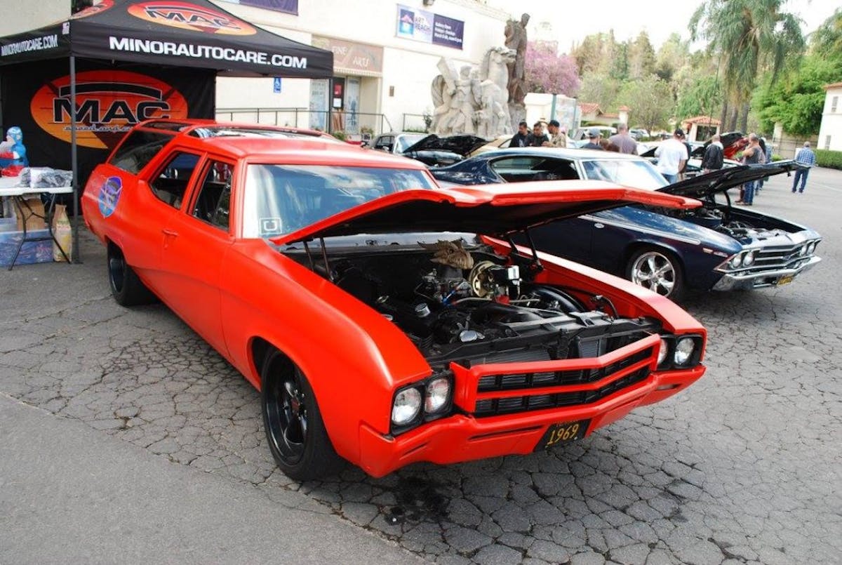 Now here's something you don't see every day - amaze red, 1969 Buick station wagon at a car show - love those rear tires.