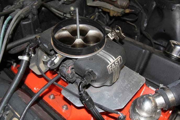 Test fitting the air cleaner housing meant using a short ½-inch Spectre spacer in order to clear the throttle linkage. This probably would not be necessary on a typical Holley carburetor, but the FAST EZ-EFI 2.0 throttle body is somewhat shorter and the linkage hit the underside of the air cleaner.