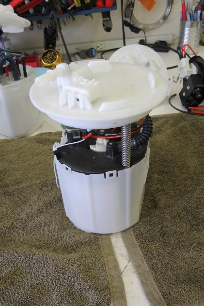The VaporWorx system centers around a factory GM fuel pump module. Inside this round plastic cage is the pump and internal reservoir. It is spring loaded to be loaded against the bottom of the tank and designed to be returnless. Even with very low fuel level in the tank, the reservoir will always remain full.