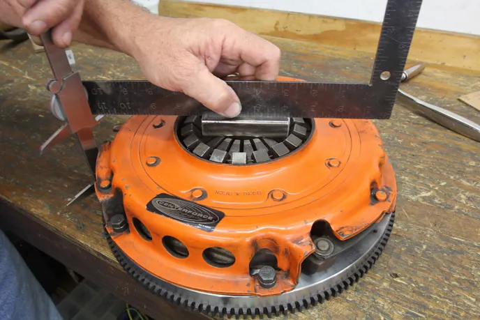 This is how to measure the pressure plate release lever height. The dimension is from the tallest point on the levers to the flywheel friction surface. According to Modern Driveline, this height is between 1.8 and 2.3 inches. This height directly affects the position of the release bearing and the release arm.