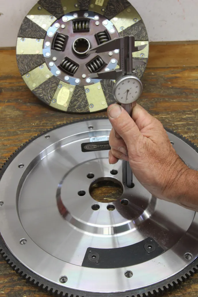 Centerforce recommends measuring the flywheel height as part of the checklist. The spec is 0.960 inch for GM engines using the mechanical clutch linkage. Measure this by inverting the flywheel on a bench and measuring from the crank flange to the bench. If the flywheel is shorter than this spec, this will require lengthening the clutch ball spec the same distance to establish the proper release arm angle.