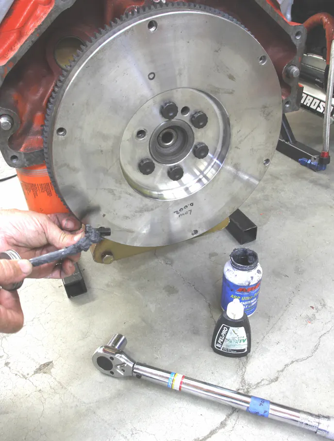 Never install flywheel bolts with lock washers or those hateful star washers. Our Centerforce flywheel came with ARP bolts, and we added a small amount of thread locking compound and then placed ARP’s Ultra-Torque under the head of the bolt. Centerforce lists 80 ft/lbs with oil and 62 ft/lbs with Ultra-Torque — that’s how much better the Ultra-Torque is at reducing friction.