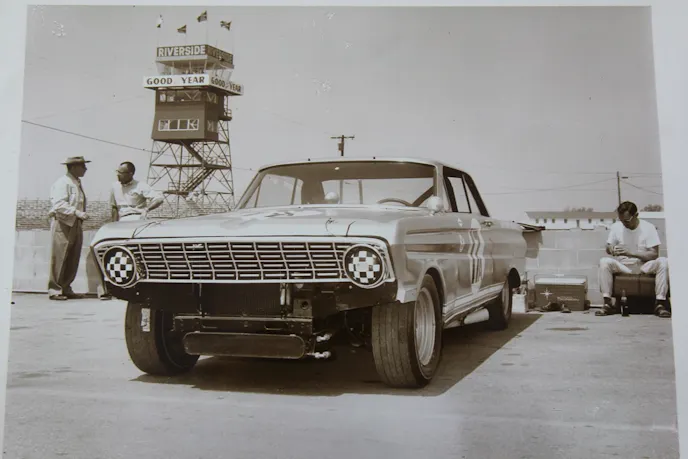 Riverside pit photo Mike says this is one of his favorite photos — showing the car in the pits at Riverside with Cordts on the far right working on an item of interest. Note the large oil cooler. Mike says, “It didn’t last long.”