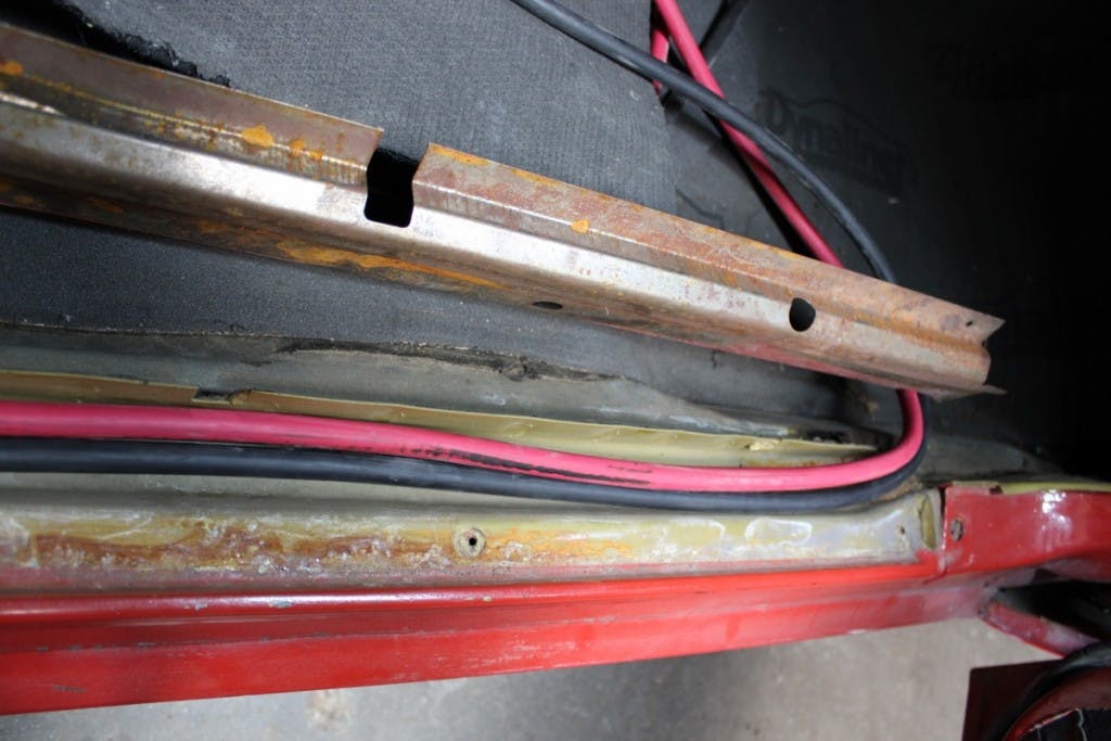 On our 1971 Camaro, the cables were easily fed from the trunk, through the rocker cover plates, and into the engine compartment. We had more than enough cable for the job.