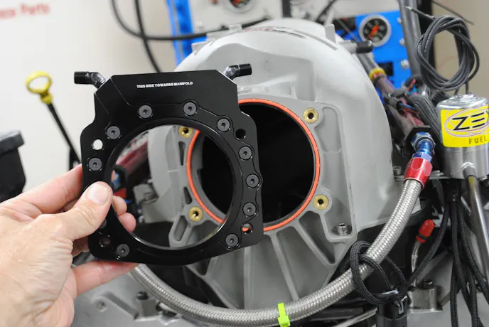 The boost-in-a-bottle portion of the equation was supplied by Zex in the form of their Perimeter Plate. The trick plate featured an insert (with o-ring) to size the opening for the desired throttle body. The plate was even labeled for proper orientation. 