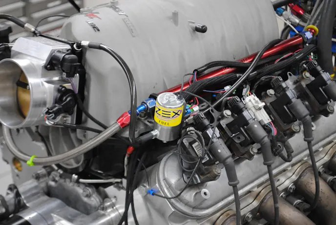 Both the fuel and nitrous solenoids were bolted in place to the FAST intake manifold. The kit featured black braided lines to feed nitrous and fuel from the solenoids to the jetting on the Perimeter plate. 